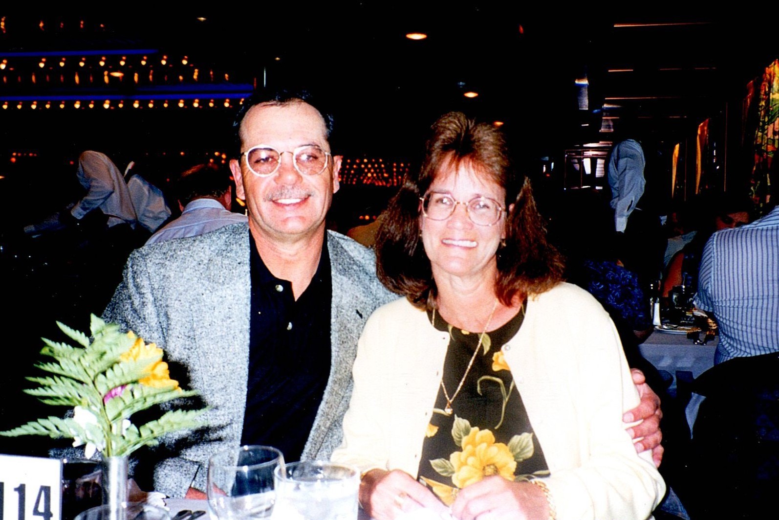 Ann Filipone smiling beside a loved one at a dinner table