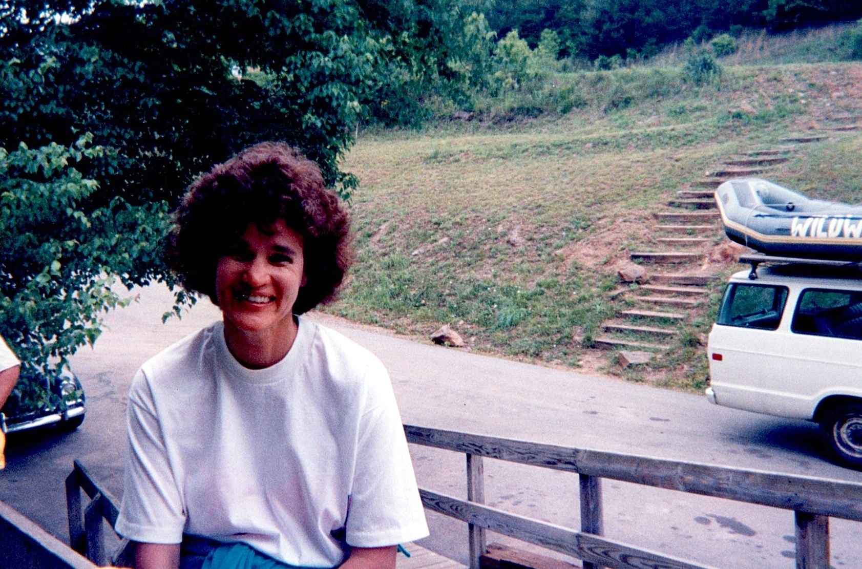 Ann Filipone smiling outside near a porch and hillside