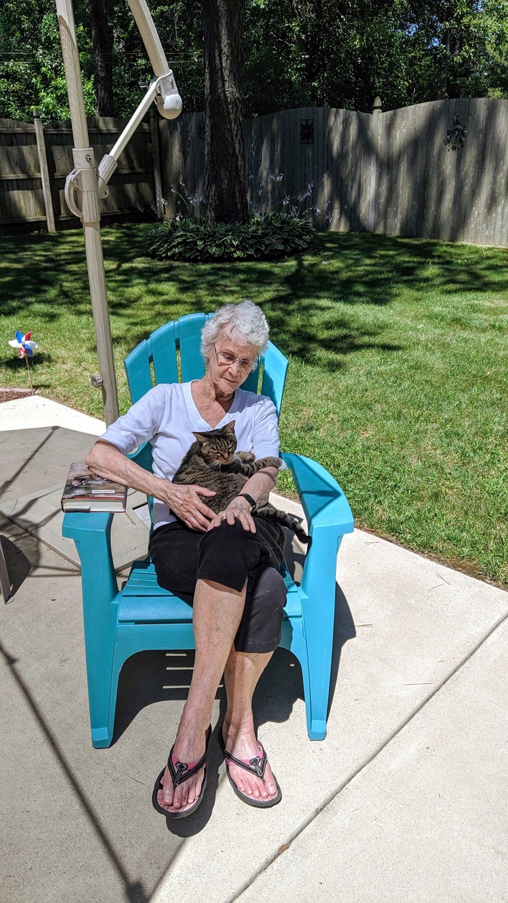 Ann Filipone sitting outside with a cat in her lap