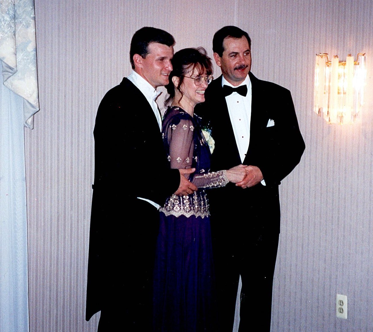 Ann Filipone dressed formally with two family members at a celebration